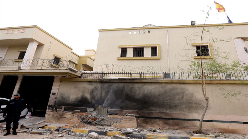 Libyan police stand guard outside the Spanish Embassy in Tripoli after a bomb exploded outside the building during the night without causing injurues, April 21, 2015.