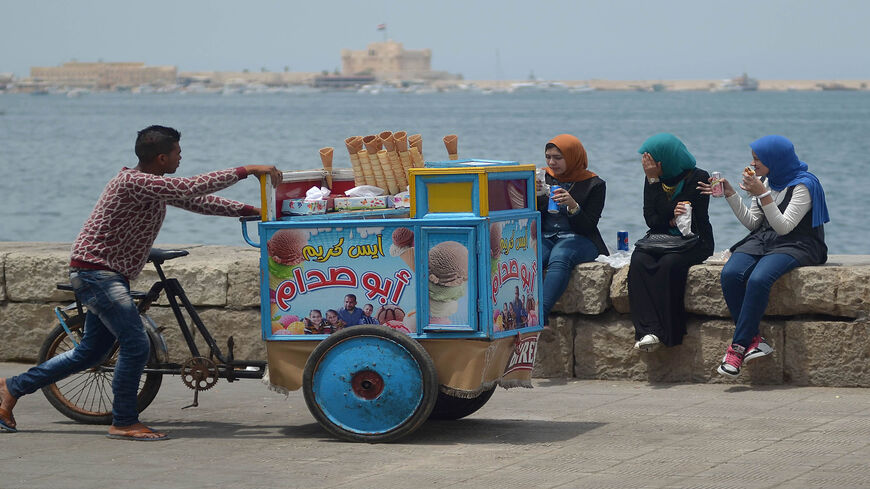 An Egyptian ice cream vendor pushes his cart in the coastal city of Alexandria, May 21, 2016.