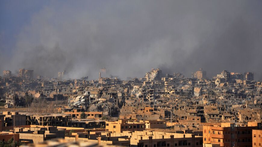 Smoke rises from buildings following an airstrike by Syrian government forces in the eastern city of Deir ez-Zor, on Oct. 31, 2017.