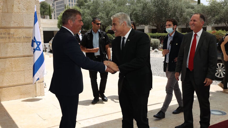 New Foreign Minister Yair Lapid greeted by outgoing Foreign Minister Gabi Ashkenazi at the Foreign Ministry, Jerusalem, June 14 2021.