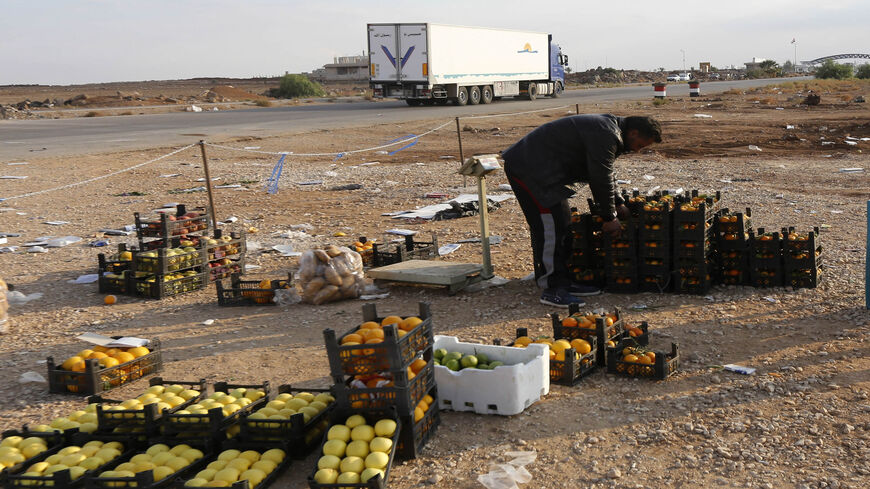 A Syrian vendor sets up his stall of fruits at the recently reopened Nassib border crossing in Daraa province, at the Syrian-Jordanian border south of Damascus, Nov. 7, 2018.