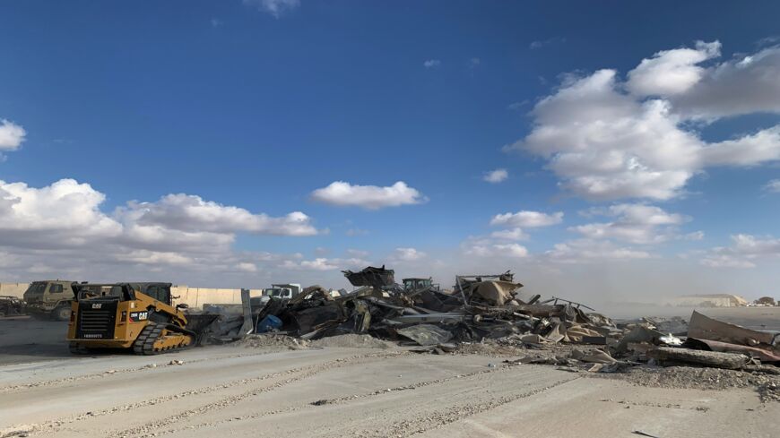 A picture taken on January 13, 2020, during a press tour organized by the US-led coalition fighting the remnants of the Islamic State, shows a bulldozer clearing debris from Ain al-Asad military air base in the western Iraqi province of Anbar.