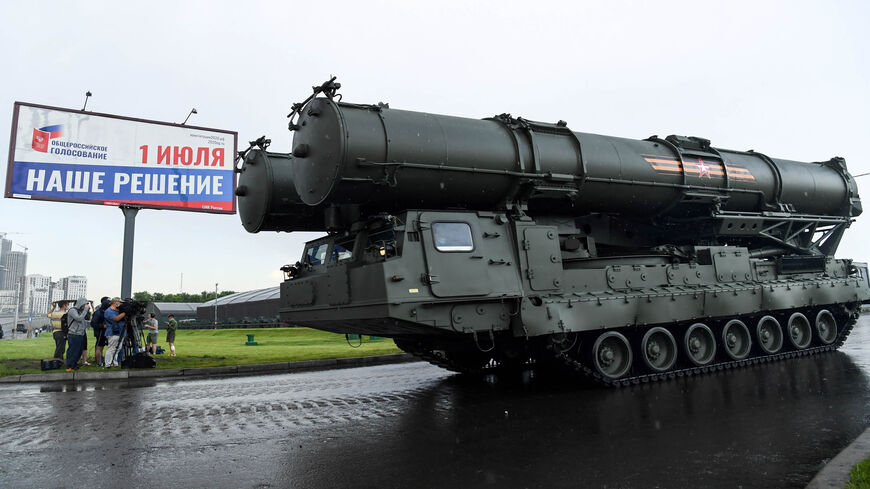 A Russian S400b4 anti-aircraft rocket system rolls past during the second night of rehearsals in preparation for the WWII Victory Parade in front of a banner informing of a national vote on constitutional changes in Moscow. Russia, June 18, 2020.