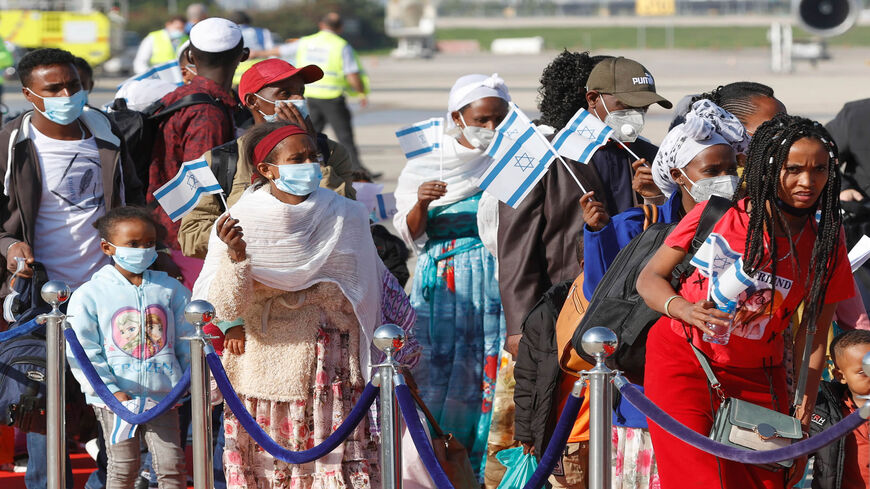 Ethiopian Jewish immigrants are pictured mask-clad as protection against the coronavirus upon their arrival at Ben Gurion International Airport, on the outskirts of Tel Aviv, Israel, Dec. 3, 2020.