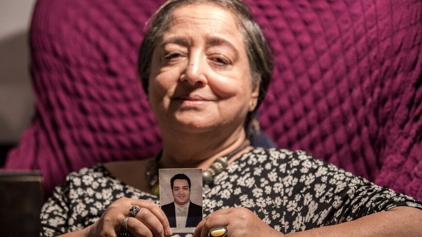Egyptian mother holds picture of imprisoned son