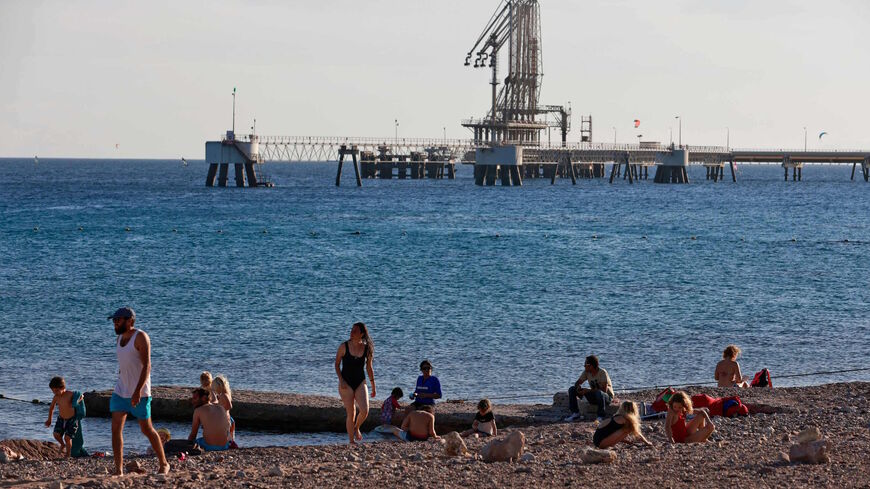 People and children gather at a Red Sea beach near the Eilat-Ashkelon Pipeline Company's (EAPC) oil terminal by Israel's southern port city of Eilat on Feb. 10, 2021.  