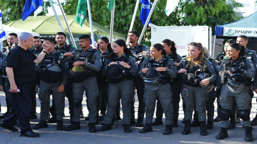 Israeli Prime Minister Benjamin Netanyahu meets with members of the Israeli border police in the central city of Lod, near Tel Aviv, on May 13, 2021, a day after Israeli far-right groups clashed with security forces and Arab Israelis.