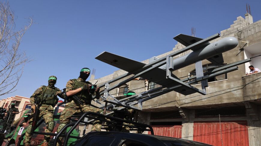 Members of Izz ad-Din al-Qassam Brigades, the armed wing of the Palestinian Hamas movement, parade with a drone in Rafah in the southern Gaza Strip on May 28, 2021.
