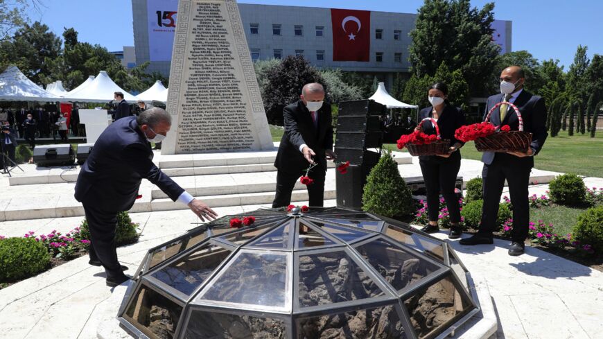 Turkish President Recep Tayyip Erdogan (C) and Turkish Parliament Speaker Mustafa Sentop (L) lay flowers during a commemorative ceremony marking the fifth anniversary of the failed coup.