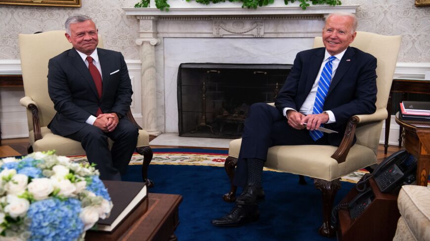 US President Joe Biden (R) and Jordan's King Abdullah II smile during a meeting in the Oval Office of the White House in Washington, DC, on July 19, 2021. 