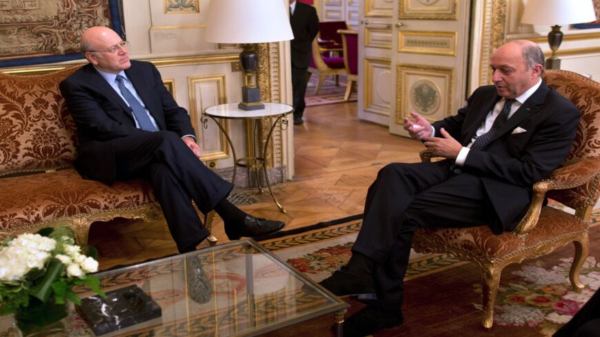 French Minister of Foreign Affairs Laurent Fabius (R) meets Lebanese Prime Minister Najib Mikati on November 26, 2013.