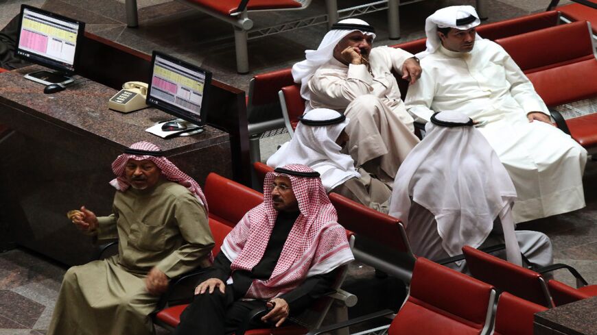 Kuwaiti traders follow the market movements at the Stock Exchange in Kuwait City on Dec. 17, 2014. 