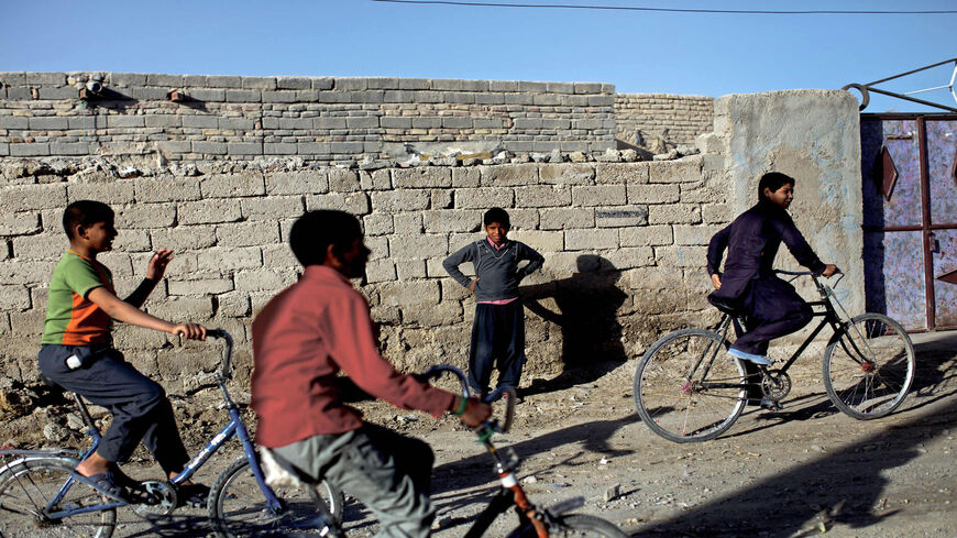 Iranian boys ride their bicycles in Adimi village in Hamoon wetland near the Zabol town in southeastern province of Sistan-Baluchistan, bordering Afghanistan, Feb. 2, 2015.