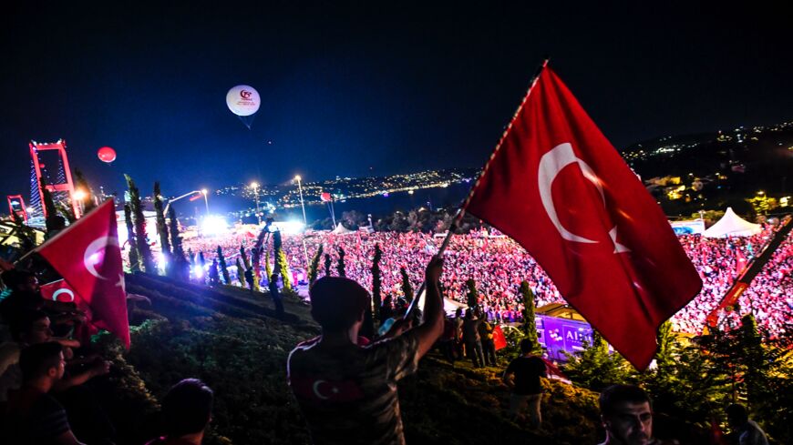 People gather at the July 15 Martyrs Bridge to commemorate the July 15, 2016, coup anniversary in Istanbul, on July 15, 2018. 