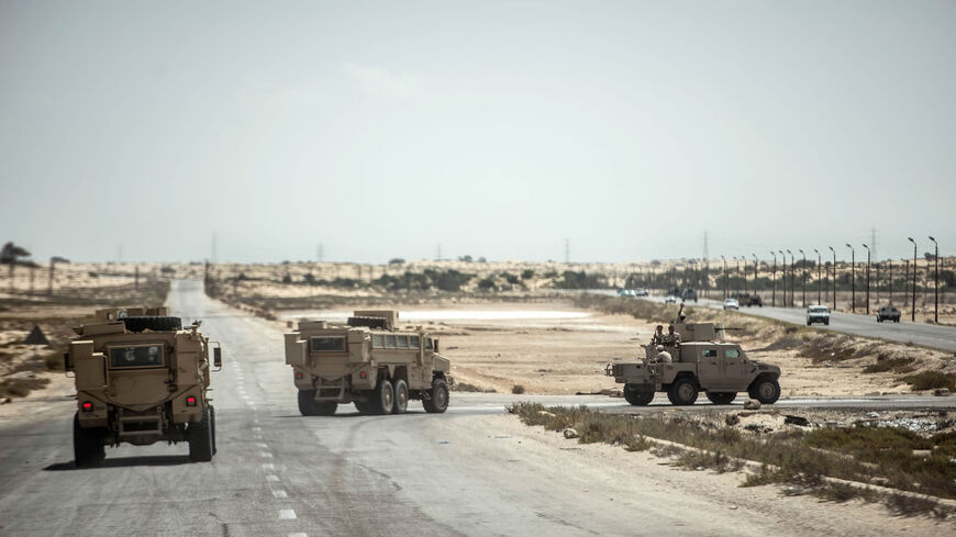 This picture shows Egyptian policemen driving on a road leading to the provincial capital of El-Arish, northern Sinai Peninsula, July 26, 2018.