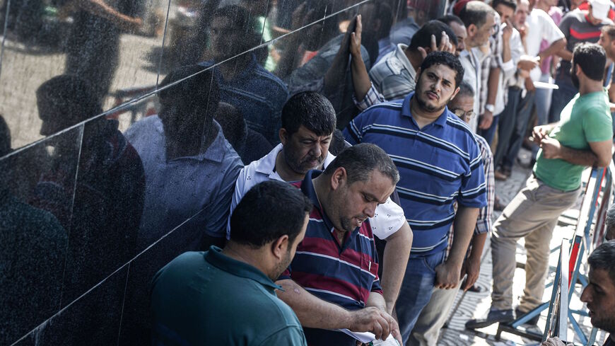 Palestinians stand in line outside the post office to receive Qatari cash aid in Gaza City, Gaza, on Aug. 26, 2019. The aid was the latest in a succession of payments to needy families in the Gaza Strip from Qatar. Israel held up the payments this year in an attempt to ensure that Hamas could not use any of the cash for its military activities; payments now will be directly made into Gazans' bank accounts via the United Nations.