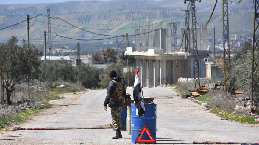 A Syrian army soldier stands guard at a checkpoint in the village of Kafr Nabl in Syria's northwestern Idlib province on March 7, 2020 as government forces assumed control over it. 
