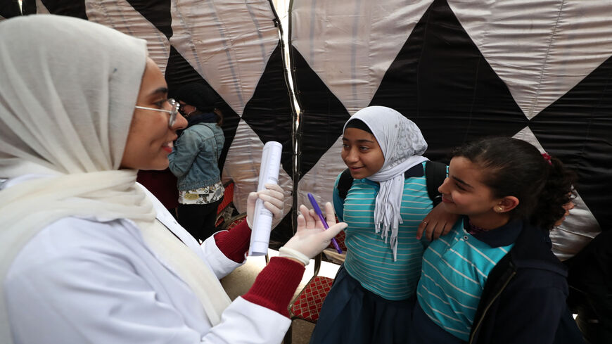An Egyptian doctor gives medical advice to girls about female genital mutilation during an awareness campaign in Giza, on the outskirts of Cairo, Egypt, Feb. 18, 2020.