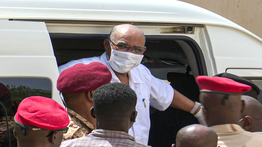 This AFPTV screenshot from footage aired July 21, 2020, shows Sudan's ousted President Omar al-Bashir disembarking from a vehicle upon arriving at the courthouse to attend his trial along with 27 other co-accused, in the capital Khartoum, Sudan.