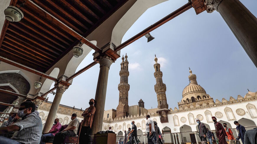 Muslim worshippers, mask-clad due to the COVID-19 coronavirus pandemic, arrive at the courtyard of the historic al-Azhar mosque in the centre of Islamic Cairo to perform the Friday prayers under new pandemic restrictions, in Egypt's capital on Aug. 28, 2020. 