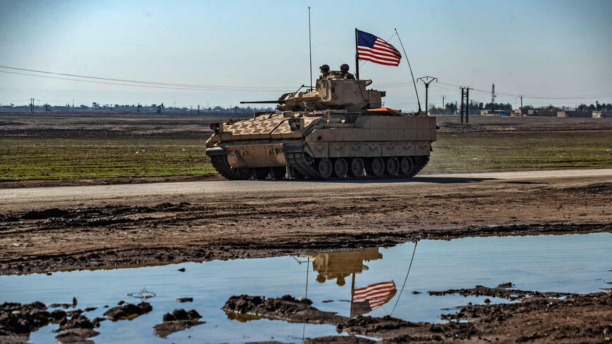 A US Bradley Fighting Vehicle patrols near oil production facilities in the countryside near al-Malikiyah (Derik), Hasakah province, Syria, Feb. 2, 2021.