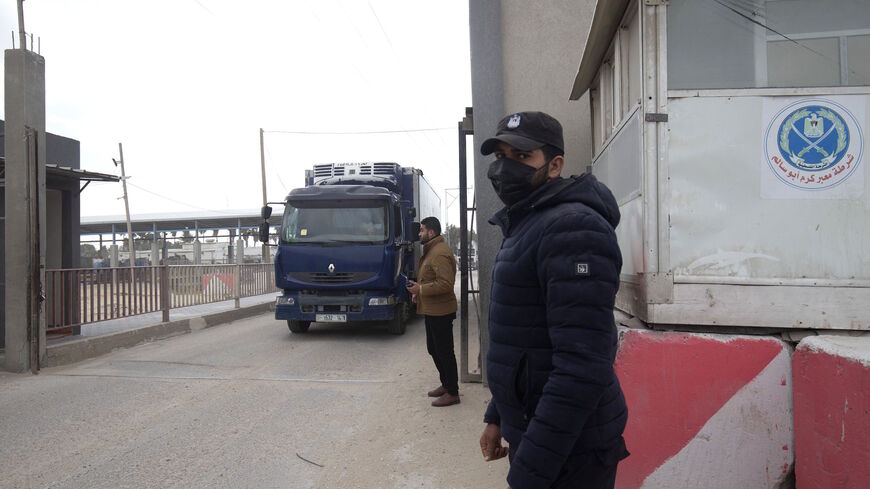 Palestinian security forces stand on guard as a truck carrying the first arriving shipment of doses of Russia's Sputnik V vaccine for COVID-19 coronavirus disease arrives on the Palestinian side of the Kerem Shalom border crossing south of Rafah in the southern Gaza Strip on Feb. 17, 2021.  