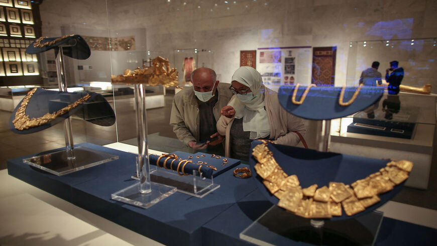 Visitors look at displayed ancient jewelry at the new National Museum of Egyptian Civilization, during its official reopening in the Fustat district of Old Cairo, Egypt, April 4, 2021.