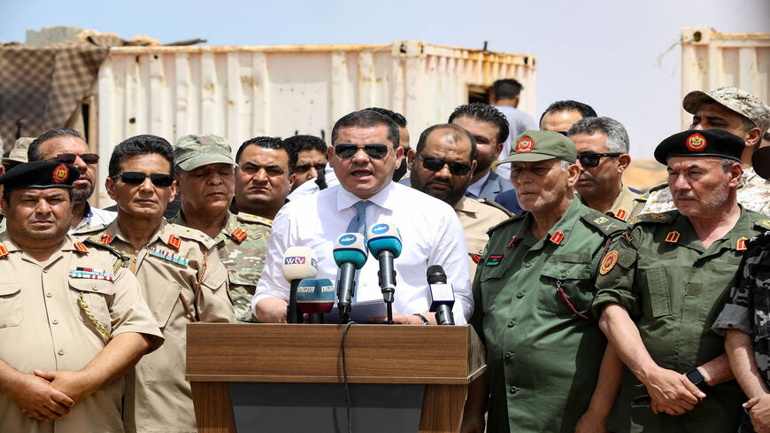 Libyan Interim Prime Minister Abdul Hamid Dbeibah delivers a speech in the town of Buwairat al-Hassoun, during a ceremony to mark the reopening of a 186-mile road between the cities of Misrata and Sirte, Libya, June 20, 2021.