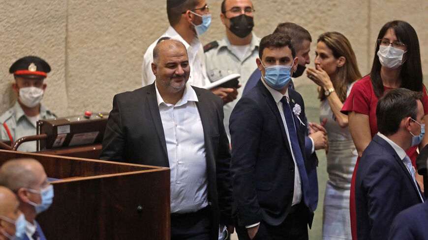 Mansour Abbas (L), head of Israel's conservative Islamic Raam party, attends a Knesset (Parliament) meeting in Jerusalem on July 7, 2021, during which Israeli President-elect Yitzhak Herzog will swear allegiance. 