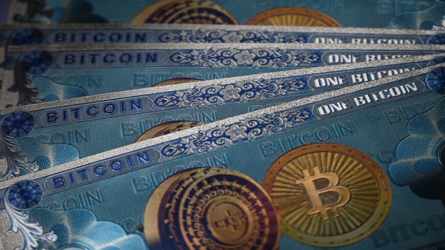 This illustration photograph taken on July 18, 2021, in Istanbul shows physical banknote imitations of the Bitcoin cryptocurrency.