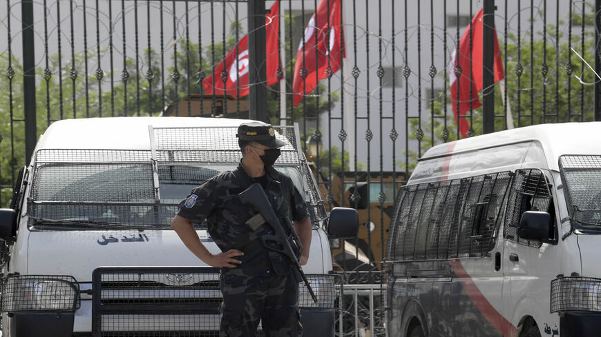 Tunisian police stand guard outside the parliament, Tunis, Tunisia, July 27, 2021.