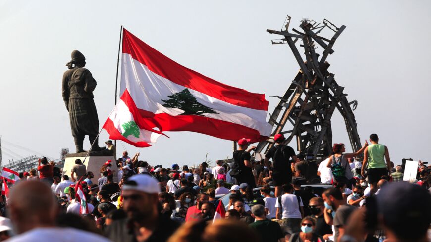 Demonstrators gather outside the port of Lebanon's capital, Beirut, on the first anniversary of the blast that ravaged the port and the city on Aug. 4, 2021.