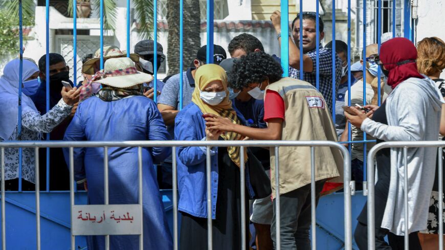 Tunisians wait for their turn to receive a COVID-19 vaccine at an inoculation center in Ariana governorate near the capital Tunis on Aug. 8, 2021.
