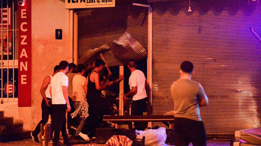 Men smash up shops and homes believed to be owned by Syrian families during an unrest, in Ankara, on Aug. 12, 2021 overnight. 