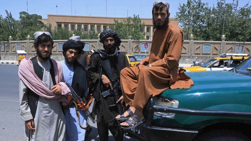 Taliban fighters stand guard in Herat