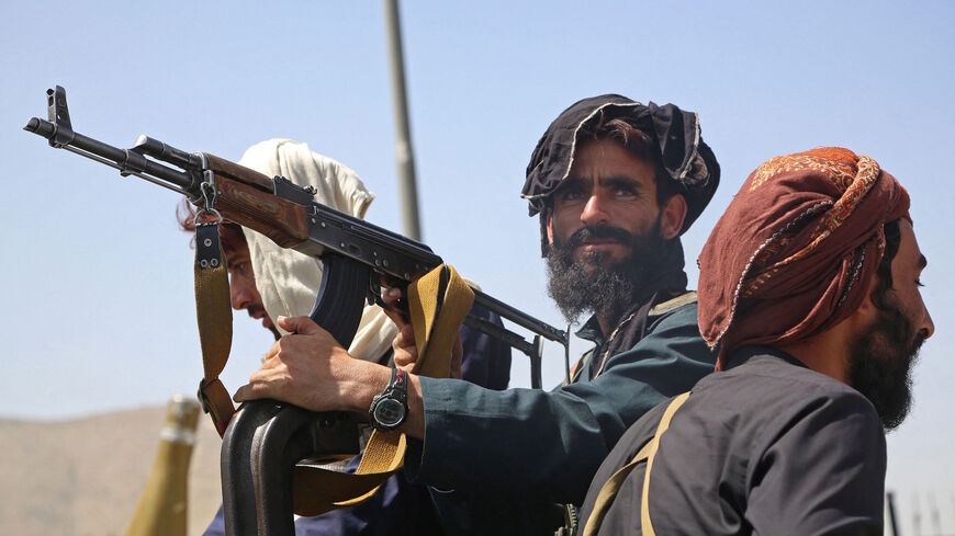 Taliban fighters stand guard in a vehicle along the roadside in Kabul on August 16, 2021, after a stunningly swift end to Afghanistan's 20-year war, as thousands of people mobbed the city's airport trying to flee the group's feared hardline brand of Islamist rule. 