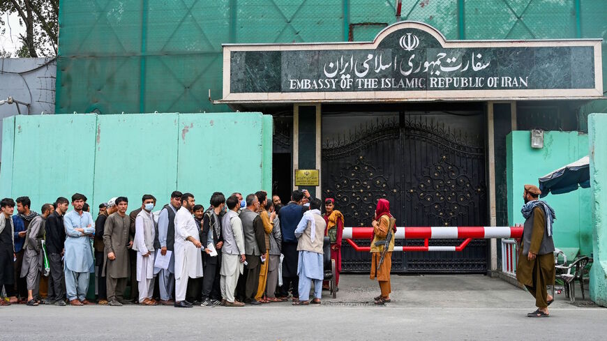 Afghan people line up outside the Iranian embassy to get a visa in Kabul on Aug. 17, 2021, after the Taliban took over Afghanistan. 