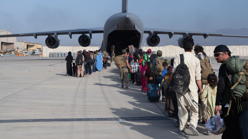 In this handout provided by U.S. Central Command Public Affairs, U.S. Air Force loadmasters and pilots assigned to the 816th Expeditionary Airlift Squadron, load passengers aboard a U.S. Air Force C-17 Globemaster III in support of the Afghanistan evacuation at Hamid Karzai International Airport (HKIA) on Aug. 24, 2021 in Kabul, Afghanistan. 