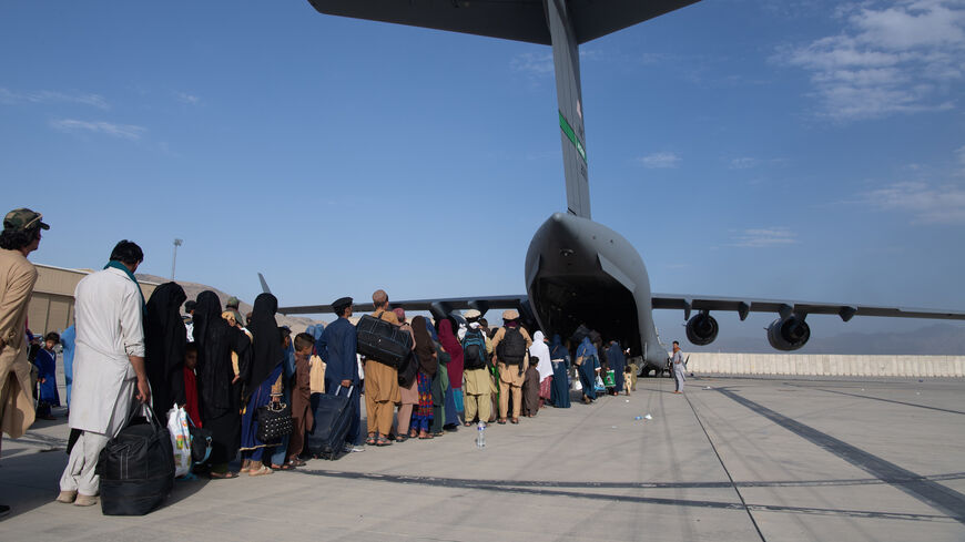 In this handout provided by U.S. Central Command Public Affairs, U.S. Air Force loadmasters and pilots assigned to the 816th Expeditionary Airlift Squadron, load passengers aboard a U.S. Air Force C-17 Globemaster III in support of the Afghanistan evacuation at Hamid Karzai International Airport (HKIA) on Aug. 24, 2021 in Kabul, Afghanistan. 