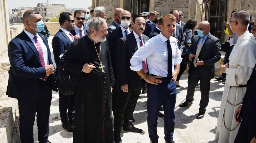 French President Emmanuel Macron (C-R) tours the Our Lady of the Hour Church in Iraq's second city of Mosul, in the northern Nineveh province, on Aug. 29, 2021. 