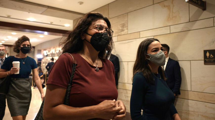 Rashida Tlaib (D-MI) (L) and Rep. Alexandria Ocasio-Cortez (D-NY) (R) arrive for a briefing with the House of Representatives on the situation in Afghanistan at the U.S. Capitol on Aug. 24, 2021 in Washington, DC.  