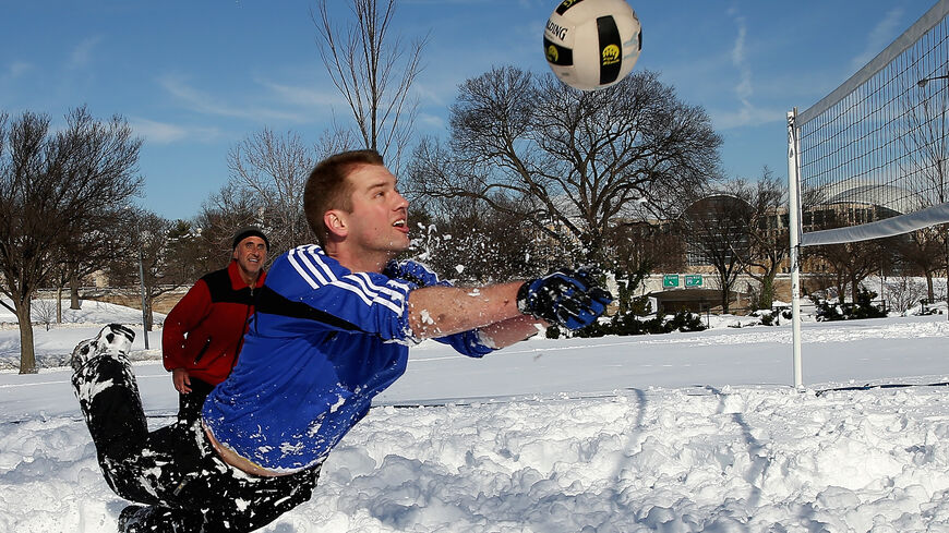 Scott Behrens dives for the ball during a friendly game of volleyball with friends in the snow Jan. 25, 2016 in Washington, DC. 