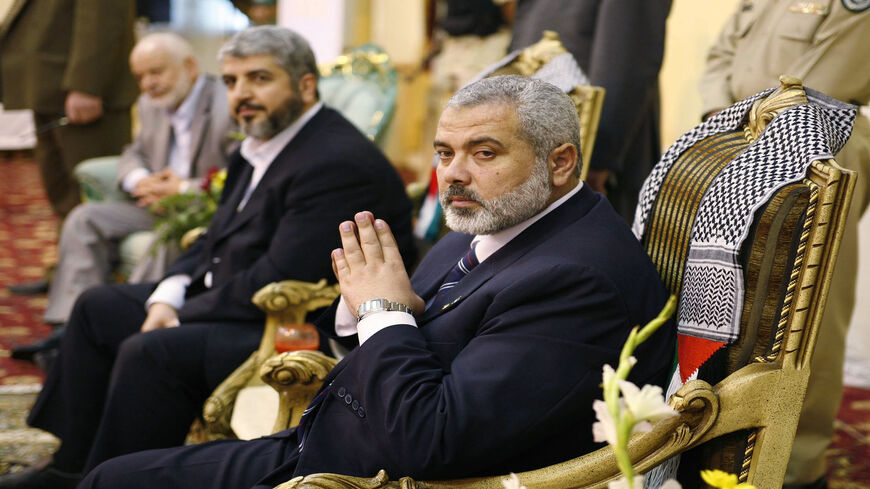 Palestinian Prime Minister Ismail Haniyeh (R) and Hamas leader Khaled Meshaal (C) are seen during a meeting with Palestinian residents in Jeddah, Saudi Arabia, Feb. 10, 2007.
