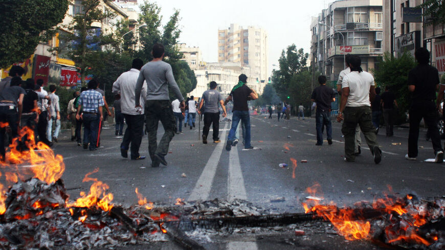 Supporters of Iran's defeated presidential candidate Mir Hossein Mousavi clash with police (unseen) during a protest in Tehran on June 20, 2009. Saeed Mortazavi had been linked to the deaths of at least four protesters arrested during rallies against the disputed re-election of then hard-line President Mahmoud Ahmadinejad.