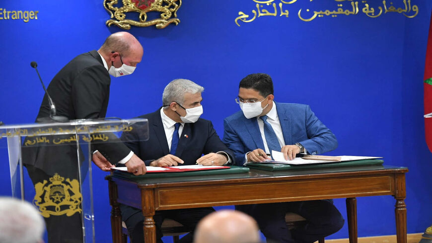 Israeli Foreign Minister Yair Lapid (L) and Moroccan Foreign Minister Nasser Bourita (R) sign three framework cooperation agreements, Rabat, Morocco, Aug. 11, 2021.