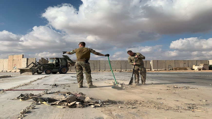 A picture taken during a press tour organized by the US-led coalition fighting the remnants of the Islamic State shows US soldiers clearing rubble at Ain al-Asad military air base, Anbar province, Iraq, Jan. 13, 2020.