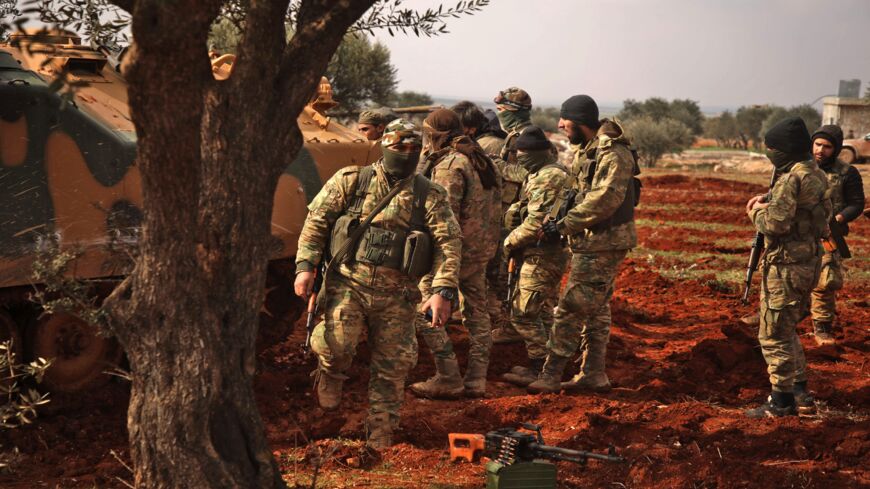 Turkish-backed Syrian fighters assemble in the village of Miznaz, on the western outskirts of Aleppo province, on Feb. 14, 2020.