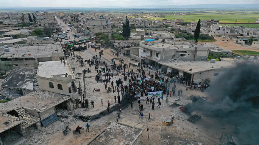 A drone images shows Syrian demonstrators gathering during a protest in the village of Maaret al-Naasan to protests against a reported attack by Hayat Tahrir al-Sham, Idlib province, Syria, May 1, 2020,