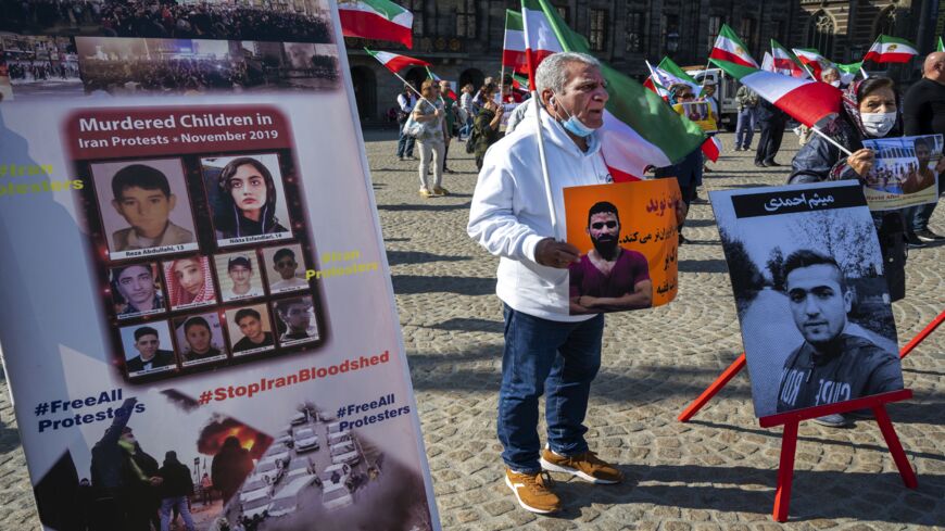 A man holds a portrait of Iranian wrestler Navid Afkari during a demonstration on the Dam Square in Amsterdam, the Netherlands, on Sept. 13, 2020.