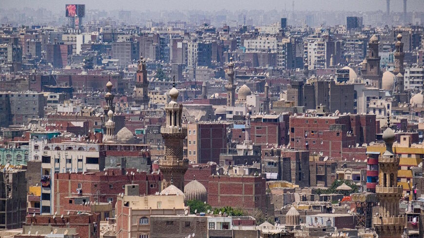 This picture taken on May 26, 2021 from the Cairo Citadel overlooking the Egyptian capital shows a view of the minarets of mosques and building rooftops in old Islamic Cairo, which gave its nickname of a "city of a thousand minarets".